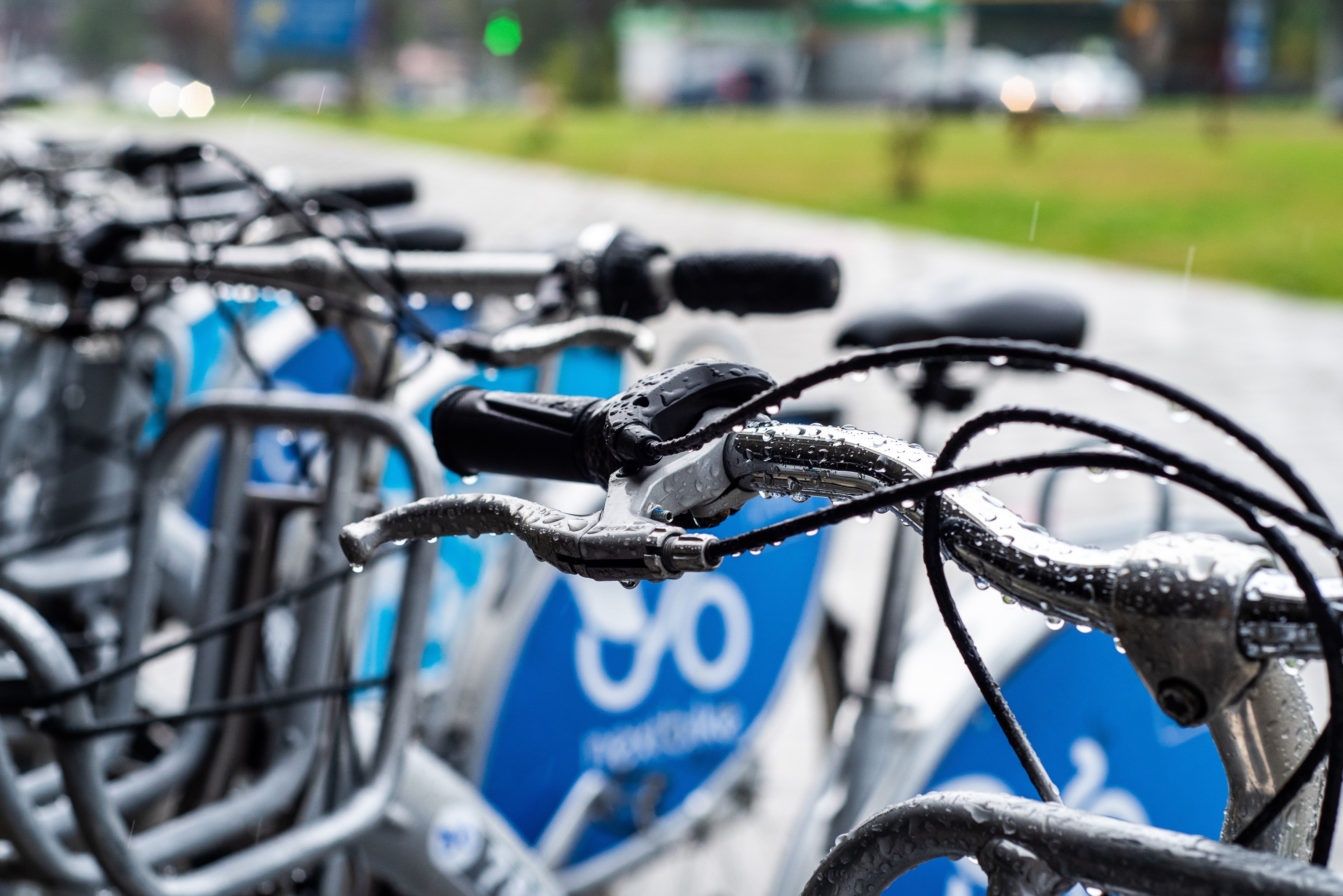 The image shows bike handlebars with wet